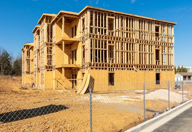 a temporary chain link fence in front of a building under construction, ensuring public safety in Santa Ana CA